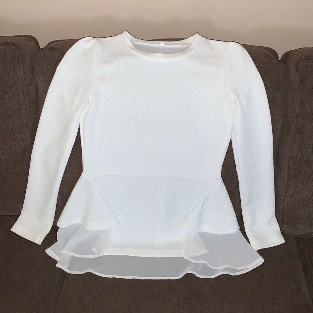 Off-white long sleeve peplum top.